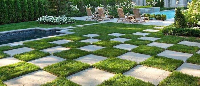 Checkerboard paver-and-lawn patio hardscape feature